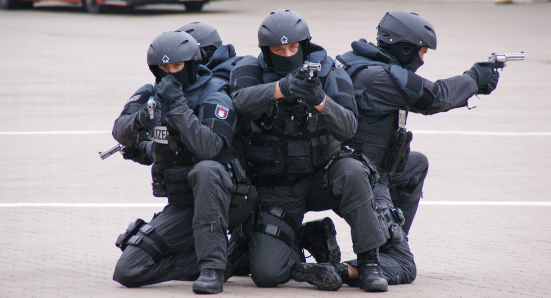 Police members pointing with guns.