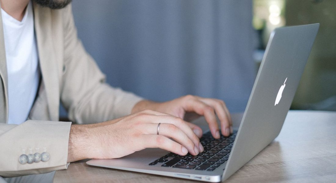 a man is browsing on his laptop and searching for mp5k host compatibility specifications