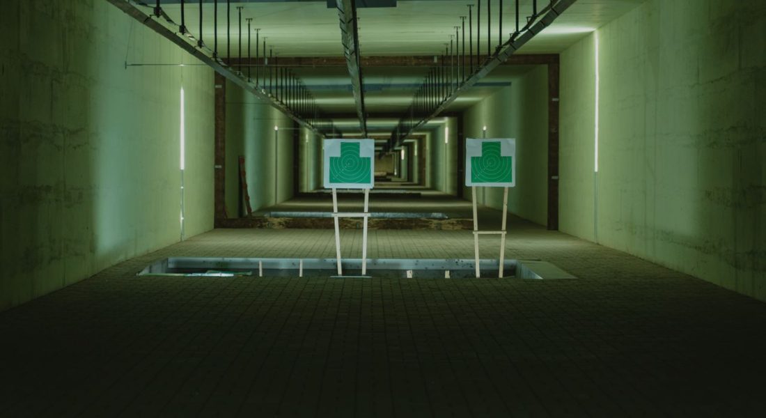a perspective view of shooting range with two green targets indoors