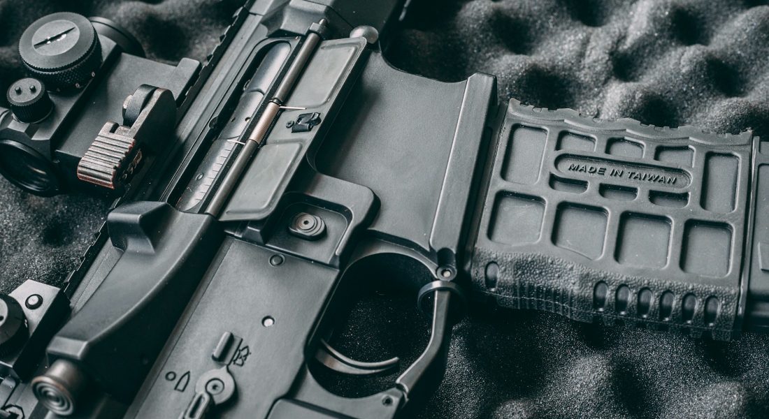 a side view of a rifle trigger
