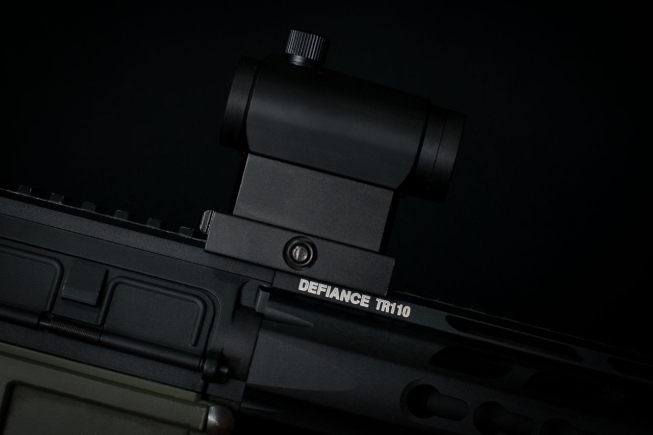 Detailed view of a rifle scope mounted on a tactical firearm