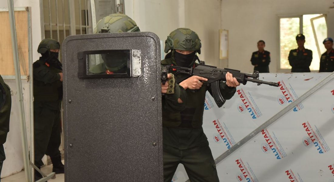 Armed security personnel conducting a tactical training exercise with rifles