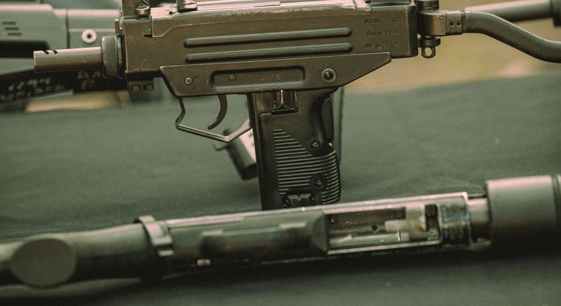 Detailed close-up of a submachine gun displayed outdoors