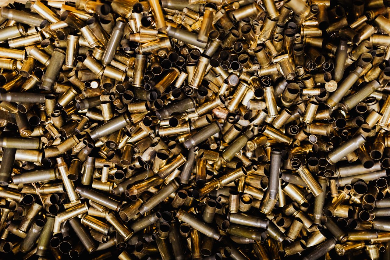 a detailed view of a pile of brass bullet casings